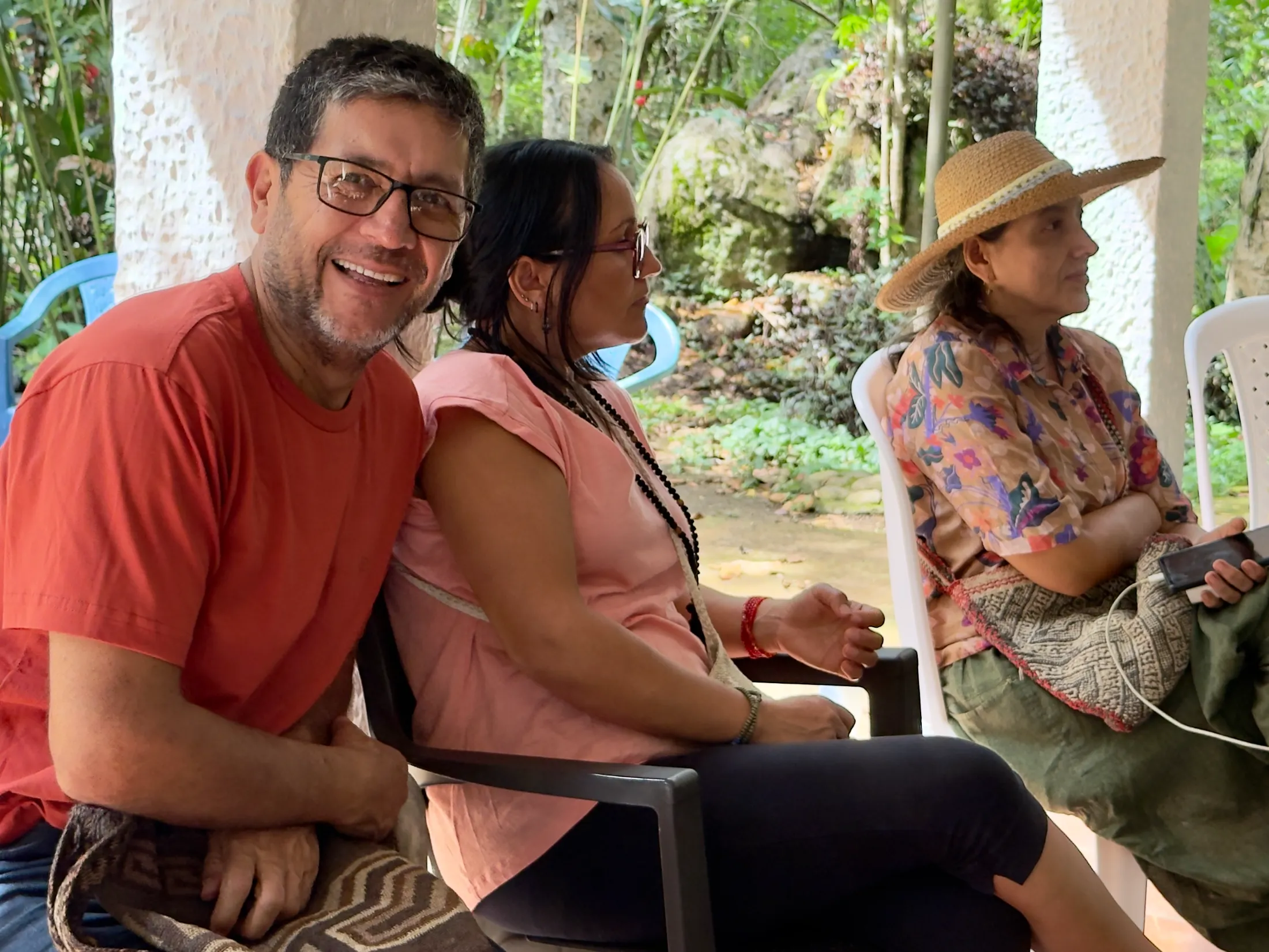 Hombres y mujeres sonríen en un encuentro al aire libre.